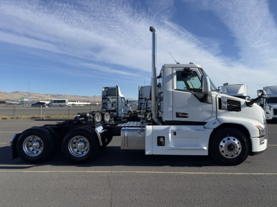 Mack PR64T conventional daycab truck side profile showing chrome wheels and exhaust stack.