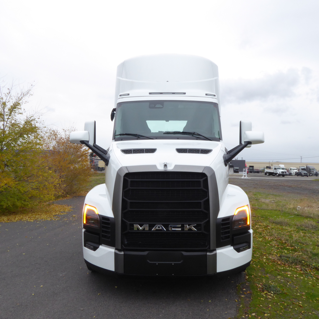 Front view of a white 2026 Mack PR64T truck showing grill, headlights, and bold 'MACK' emblem.