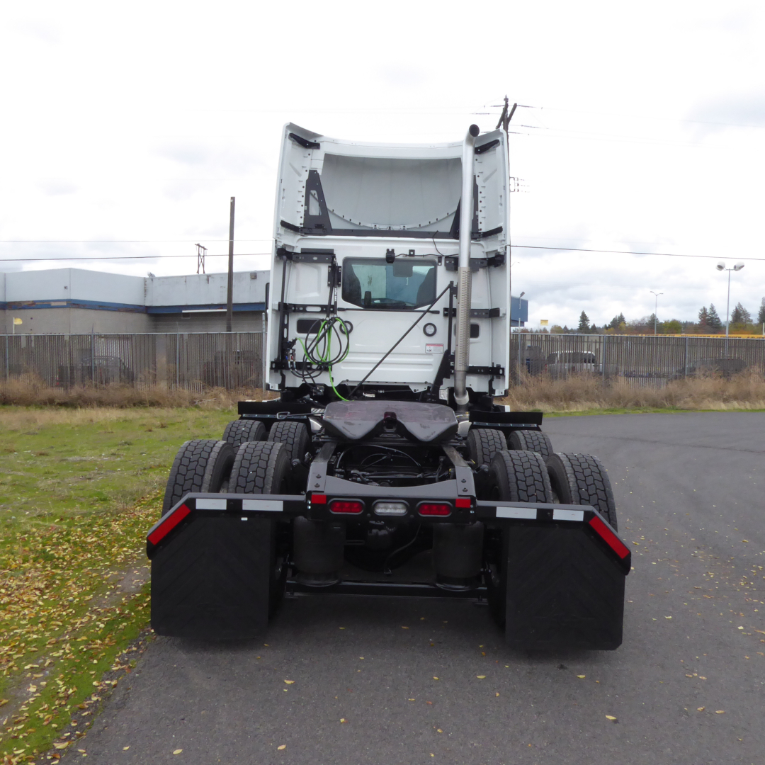 Tractor-trailer truck rear view showing fifth wheel, dual rear axles, and dual tires on a Mack PR64T chassis.