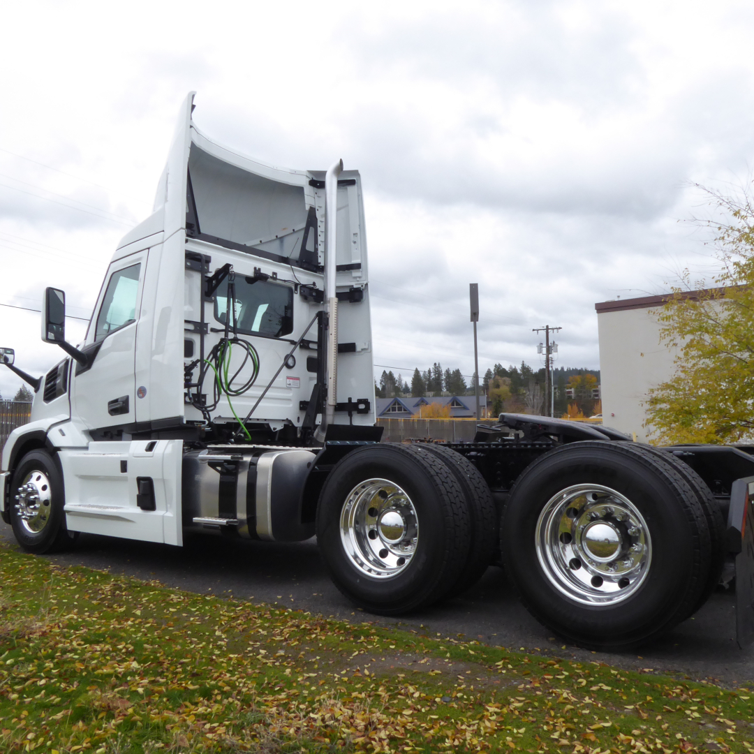 Truck tractor cab and frame side view showing exhaust and wheel assemblies for a 2026 Mack PR64T.