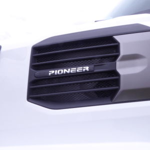 Grille of a white Mack PR64T truck showing a Pioneer emblem on the grille.