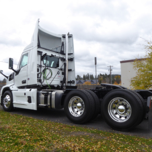 Truck tractor cab and frame side view showing exhaust and wheel assemblies for a 2026 Mack PR64T.
