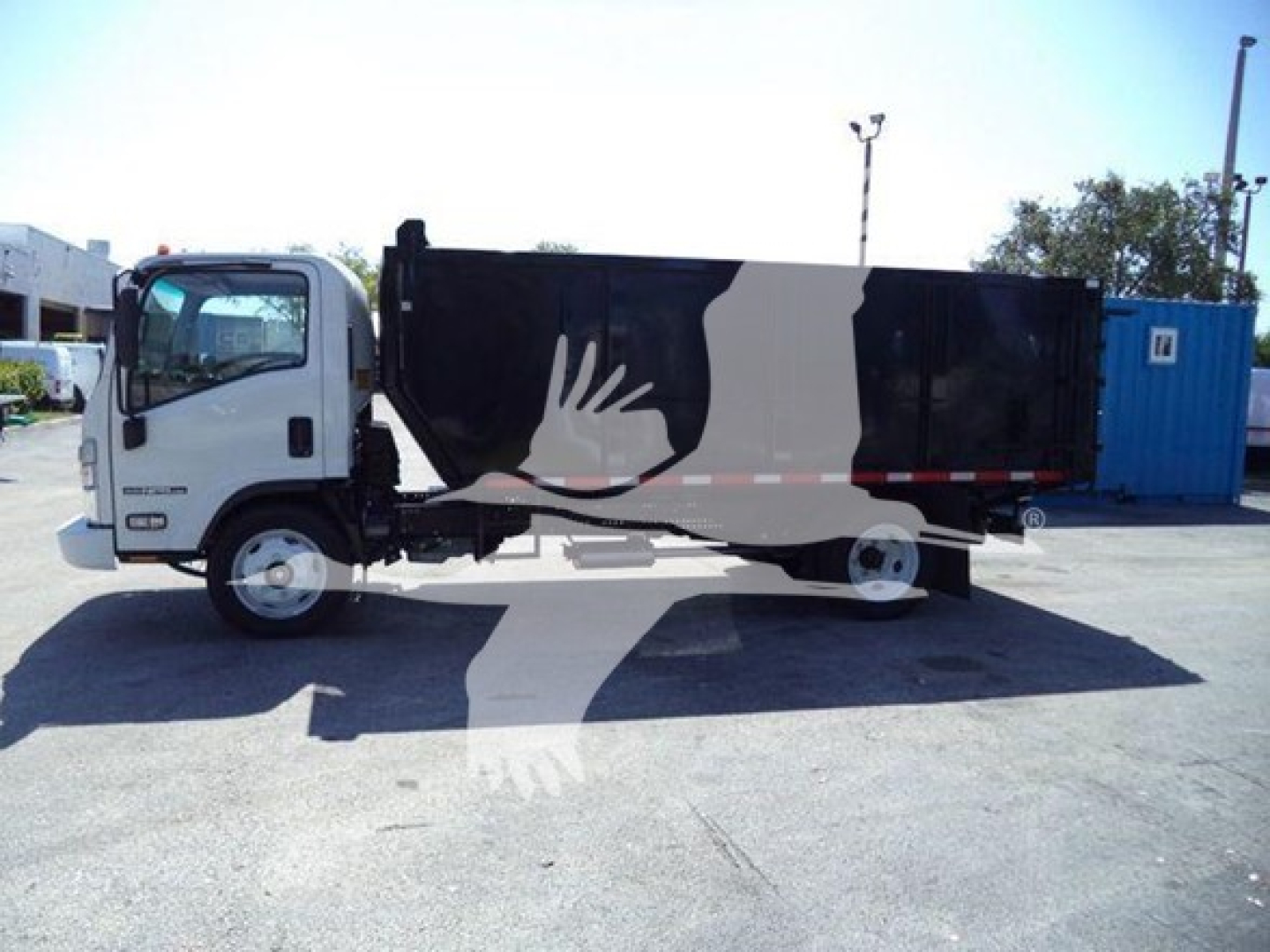 Isuzu NPR HD truck in side view with black cargo box and white cab, stock photo-like lot background.