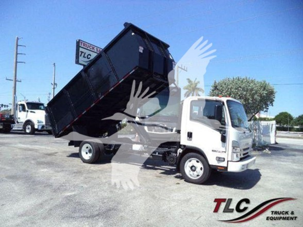 Isuzu NPR HD dump truck in yard with raised dump bed, front cab visible and TL C Truck & Equipment watermark