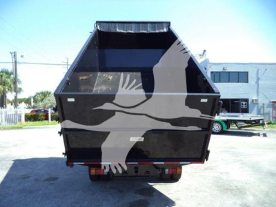Isuzu NPR HD dump truck bed seen from rear with open cargo area and tail lights.