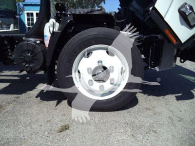 Isuzu NPR HD wheel and front suspension area visible.