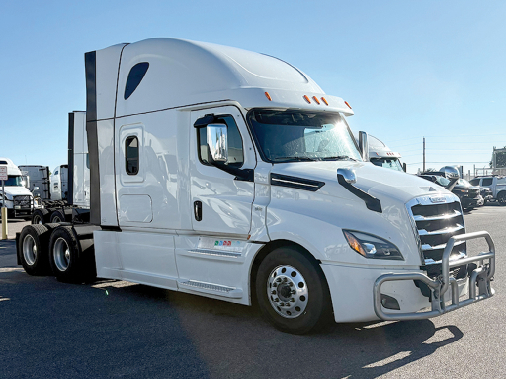 Freightliner Cascadia126 tractor cab in white, side view showing sleeper, aerodynamic mirrors, wheels, and front bumper.