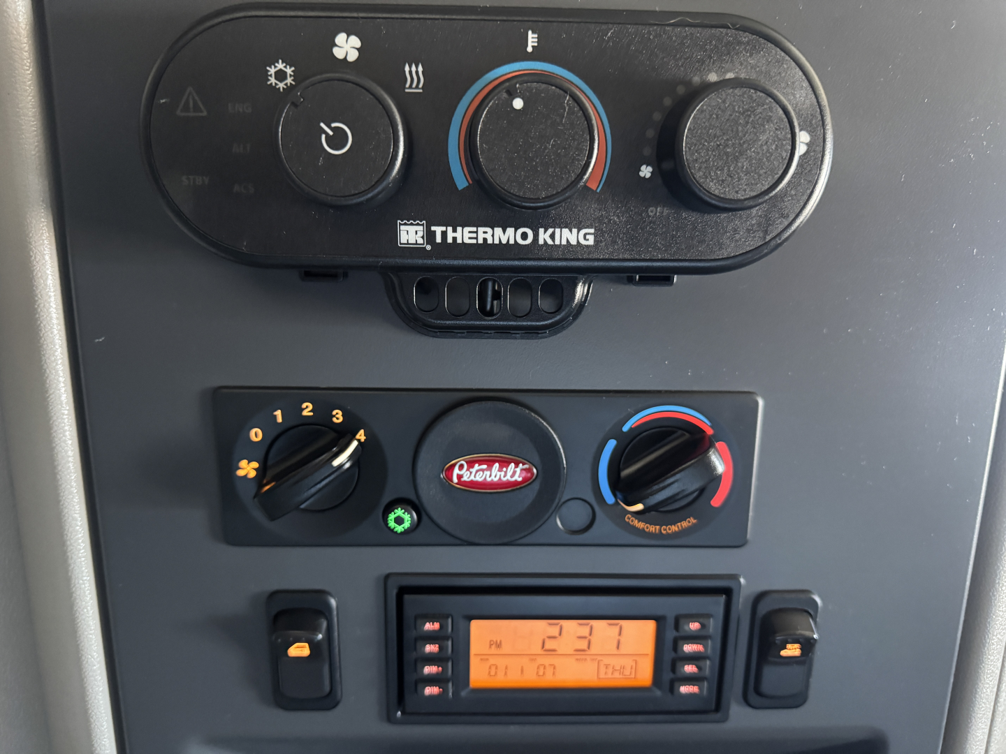 Peterbilt 579 dash close-up showing Thermo King control panel and climate dials.