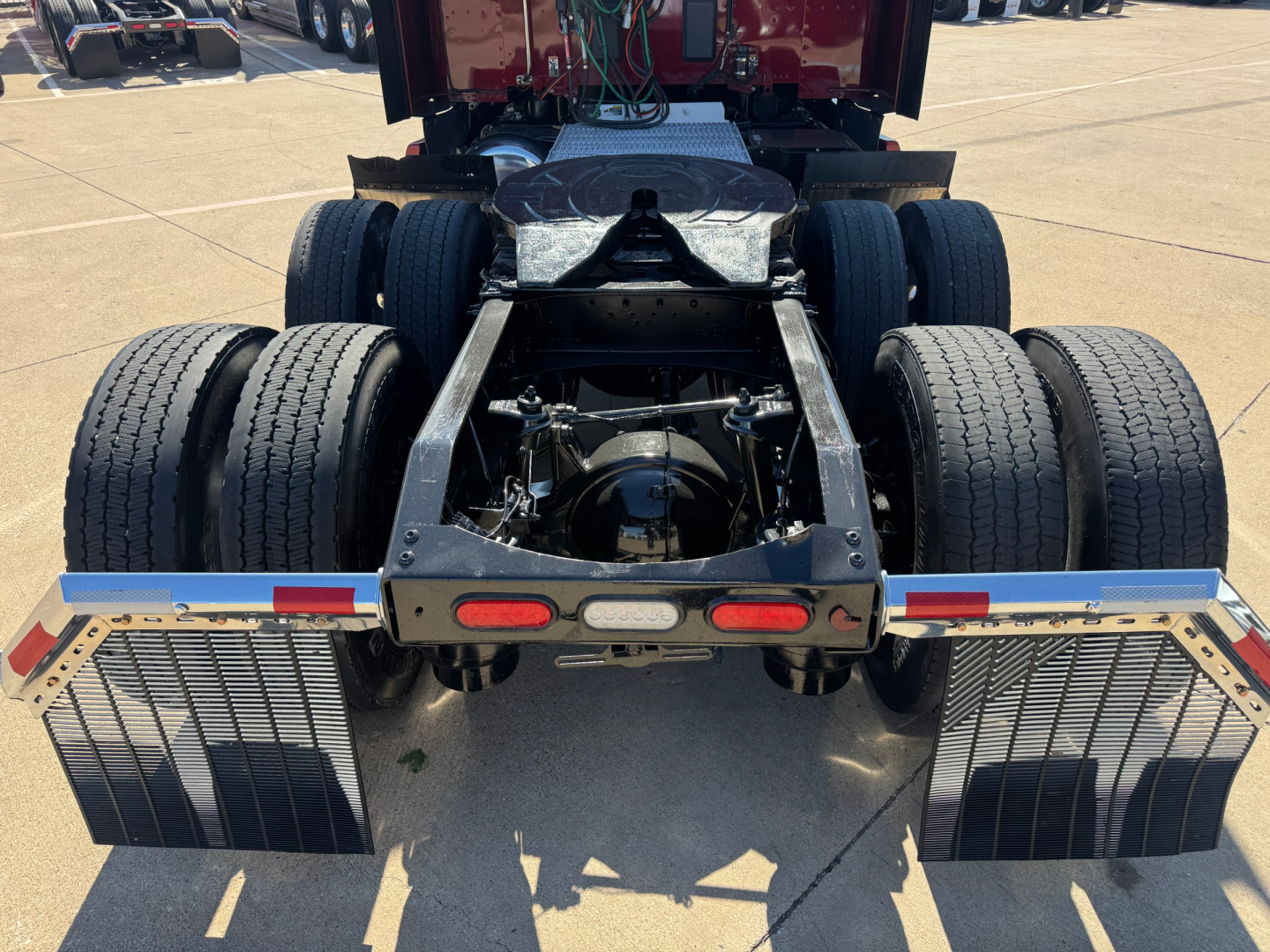 Peterbilt 579 rear chassis view showing dual rear axles, fifth-wheel attachment area, and mud flaps.