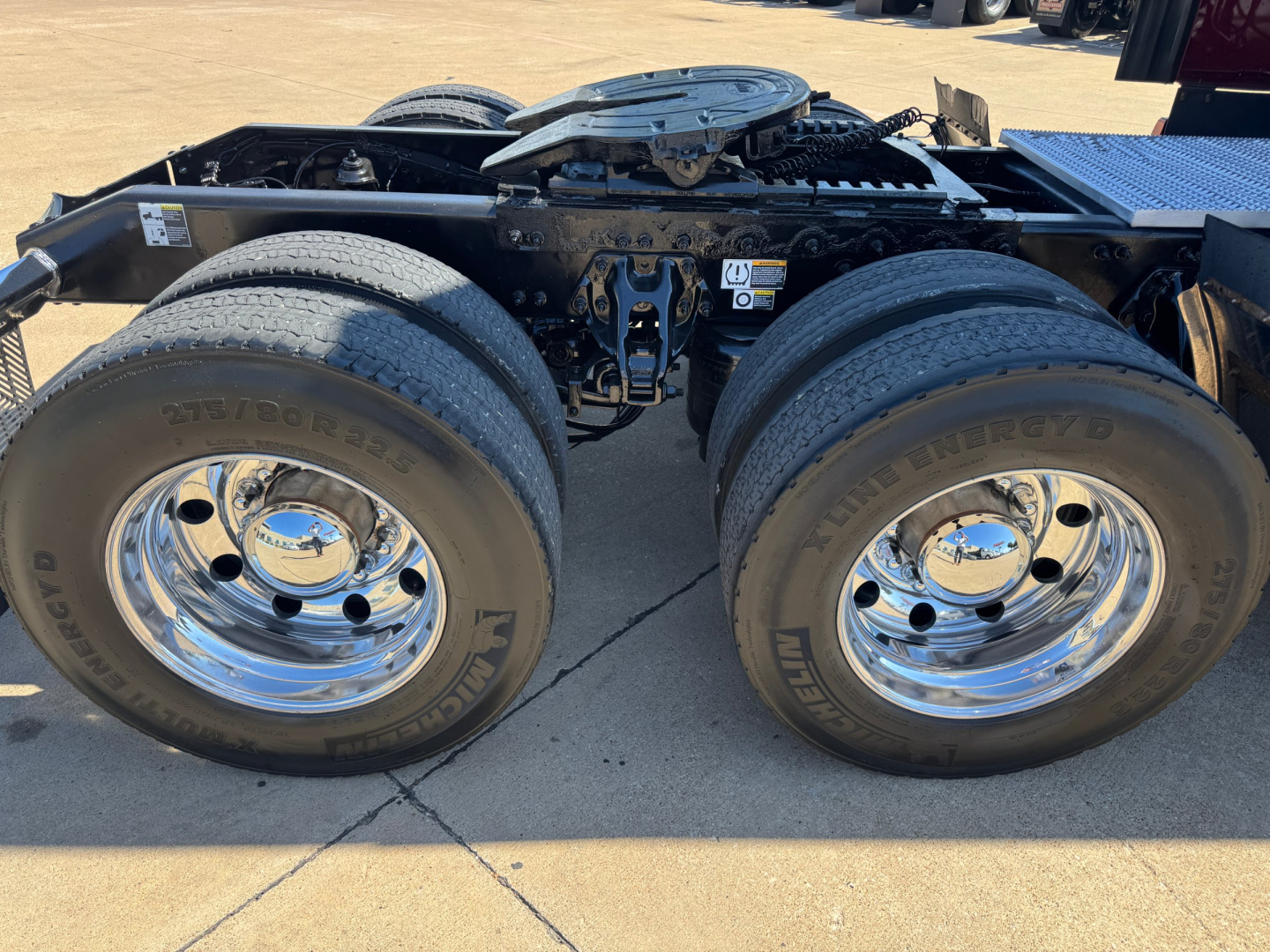 Peterbilt 579 tractor chassis with dual rear axles showing chrome wheels and tires; no visible text on side of image.