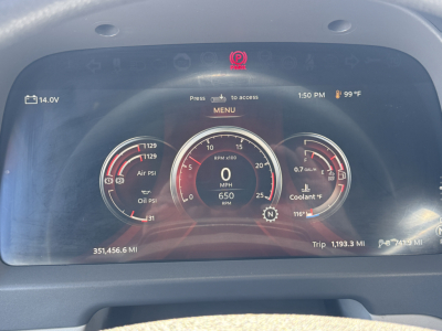 Peterbilt 579 dashboard display showing digital gauges including RPM, speed 0 MPH, oil and air pressure gauges, coolant temp, and trip mileage.