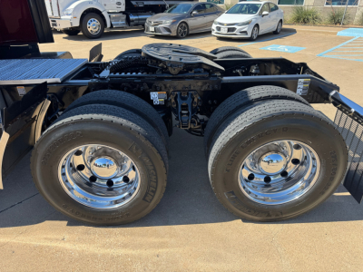 Peterbilt 579 tractor rear dual wheels view showing chrome wheels and fifth wheel hitch area.