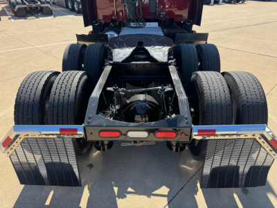 Peterbilt 579 rear chassis view showing dual rear axles, fifth-wheel attachment area, and mud flaps.
