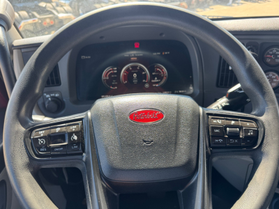 Peterbilt steering wheel and dashboard in-cab view showing instrument cluster and controls.