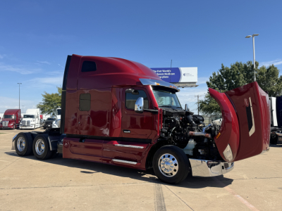 Peterbilt 579 sleeper cab truck with hood open, showing engine area and maroon exterior.