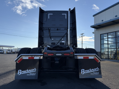 Back view of a new 2026 Mack PR64T76H conventional sleeper truck, rear chassis with dual rear tires and mud flaps labeled Bruckner’s Truck & Equipment, stock number 71511.