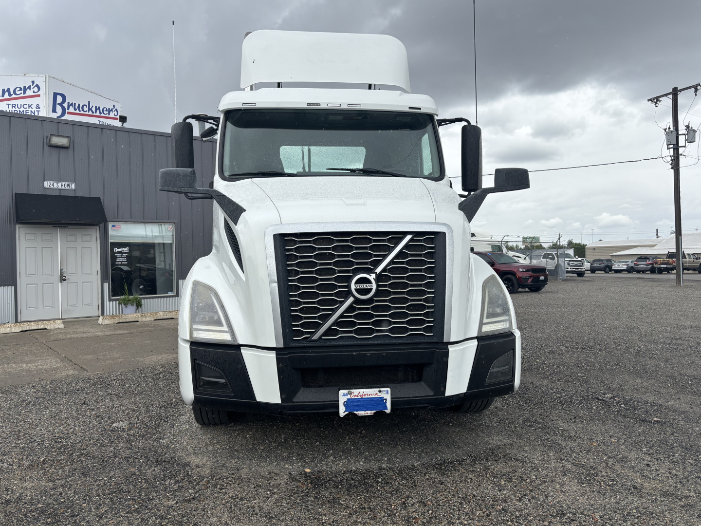 Volvo VNL84T300 truck front view showing grille and headlights with Volvo emblem.
