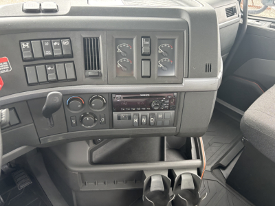 Volvo VNL dashboard and center console showing gear selector, climate controls, and instrument gauges.