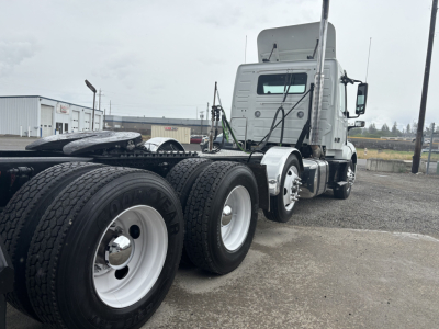 Volvo VNL84T300 daycab truck in-service showing side profile with tandem rear axles, dual rear tires, and sleeper cab.