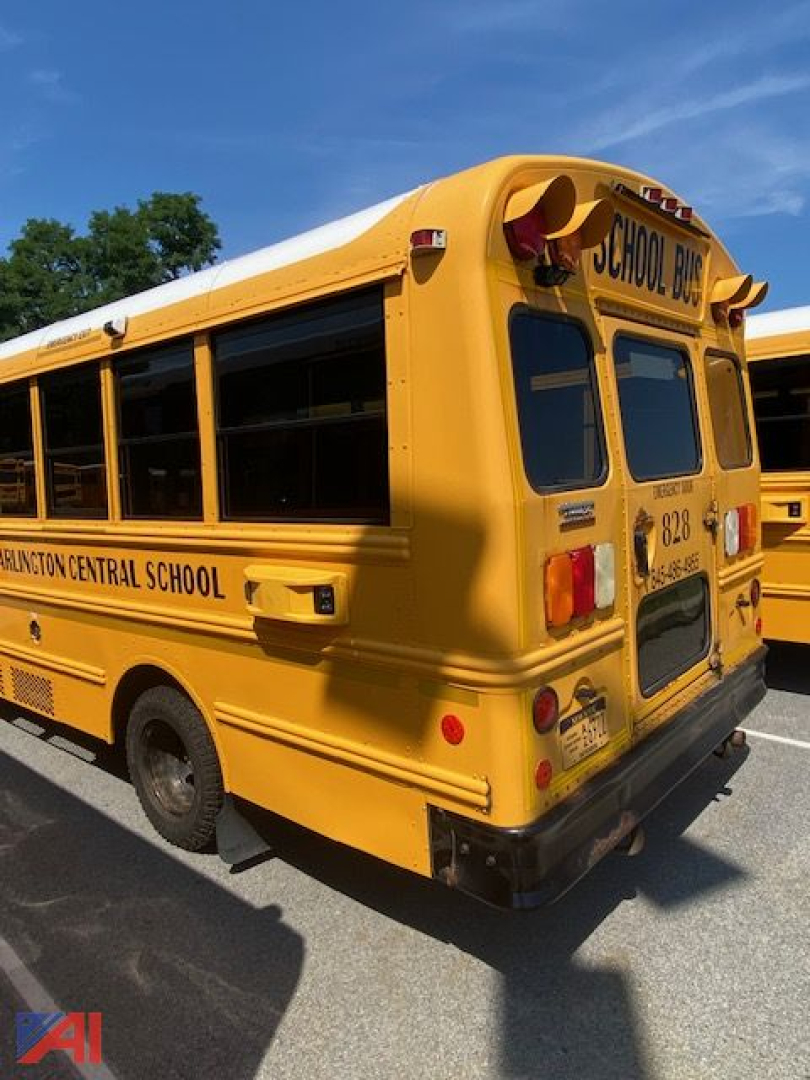 Rear and side view of a yellow Chevrolet Thomas DRW 30 passenger school bus, showing school bus lettering and rear bumper.