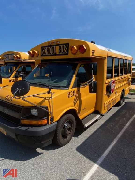 Yellow Chevrolet Thomas DRW school bus side-front view showing 'SCHOOL BUS' sign on top, bus number 828, rear-view mirrors, black tires, and passenger windows.