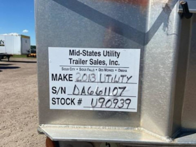 Trailer side with white label reading: Mid-States Utility Trailer Sales, Inc. MAKE 2013 UTILITY; S/N DA661107; STOCK # U90939.