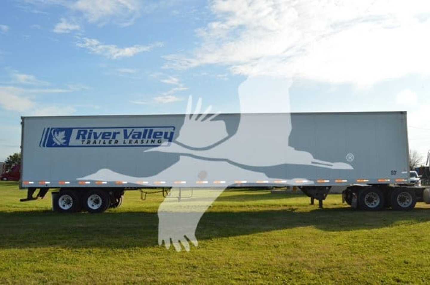 Trailer side showing River Valley logo and blue text on a white River Valley trailer.