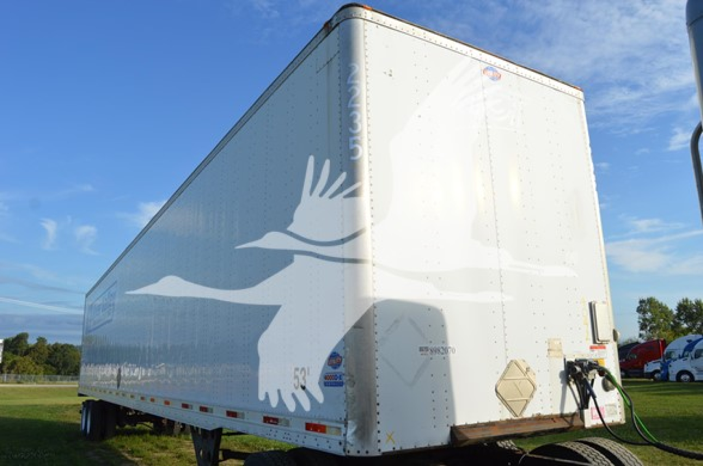 Utility trailer 4000Dx side view showing white box trailer with front hitch and reflective markings