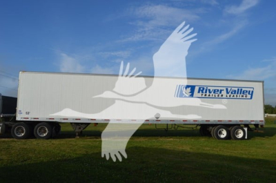 Trailer side view showing River Valley logo and model 4000Dx; long box trailer on dual-axle with white exterior.