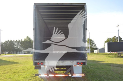 Trailer rear view showing cargo area with open ramp, Utility 4000Dx branding not visible from this angle.