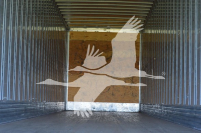 Trailer interior showing empty cargo area with metal side walls and wooden floor
