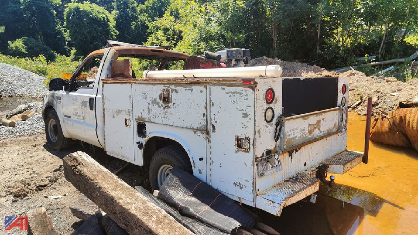 Service/utility truck bed with rear utility compartments, white paint, visible rust and wear, open cargo area, Ford F-250 Super Duty, used condition.