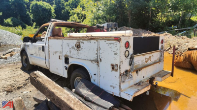 Service/utility truck bed with rear utility compartments, white paint, visible rust and wear, open cargo area, Ford F-250 Super Duty, used condition.