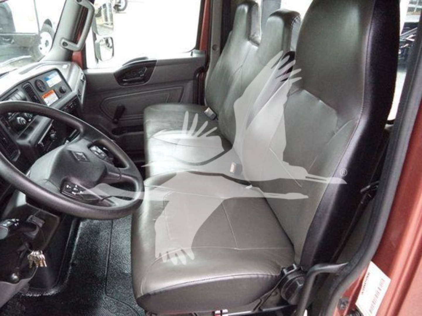 Interior view of a 2020 International MV truck cab showing front seats and steering wheel.