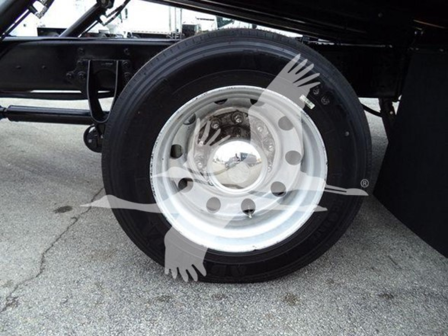 Wheel and tire assembly of a 2020 International MV truck with steel rim and black tire, partial chassis visible.