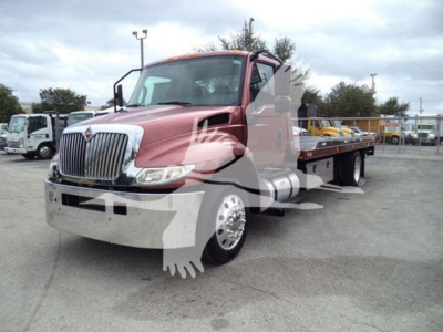 2020 International MV tow truck/rollback showing front grille and cab with flatbed body.