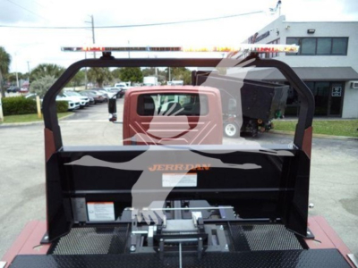 Truck bed area of a 2020 International MV rollback truck showing hydraulic controls and bed assembly.