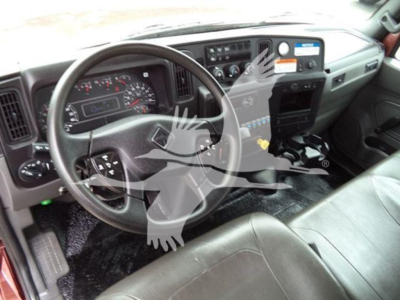 Dashboard and steering wheel of a 2020 International MV truck; various gauges, controls, and a sticker on the dash; text visible includes model year 2020 and dashboard labels.