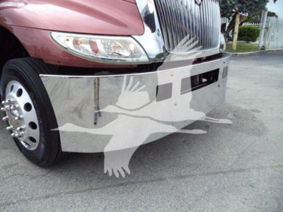 Truck front bumper and grille of a 2020 International MV rollback truck showing chrome bumper and left headlight area.