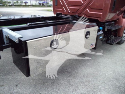 Truck rollback unit with stainless steel toolbox mounted beside the cab in a 2020 International MV showing storage box and side steps.