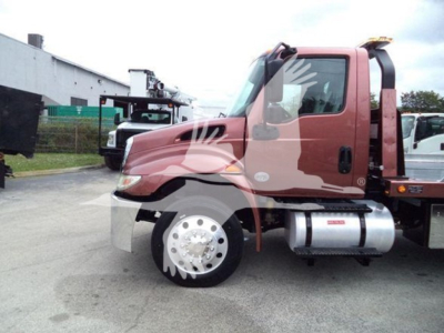 Truck cab side view showing MV model from International with large fuel tank, front wheel, and side mirrors.