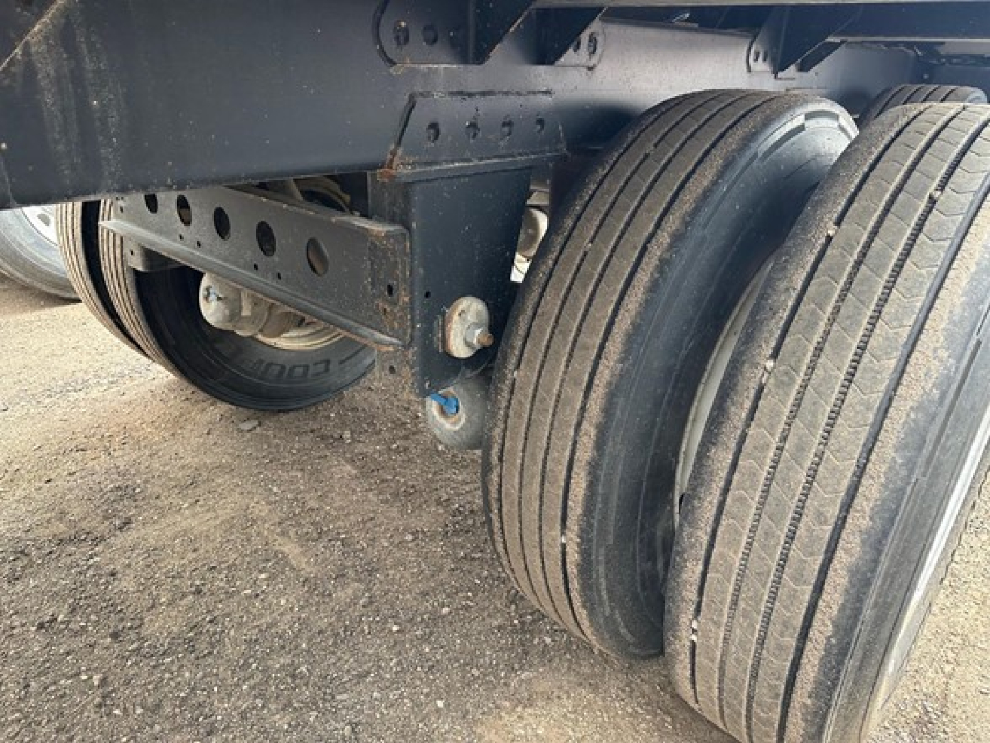 Timpte hopper trailer wheel assembly showing dual rear tires and suspension hanger.