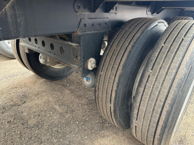 Trailer axle and dual tires of a 2024 Timpte hopper trailer with 66" sides, showing air-spring or suspension components and wheel assembly.