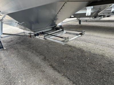 Trailer hitch area of a 2024 Timpte Super Hopper trailer showing undercarriage and support structure with metal framing and ground surface.