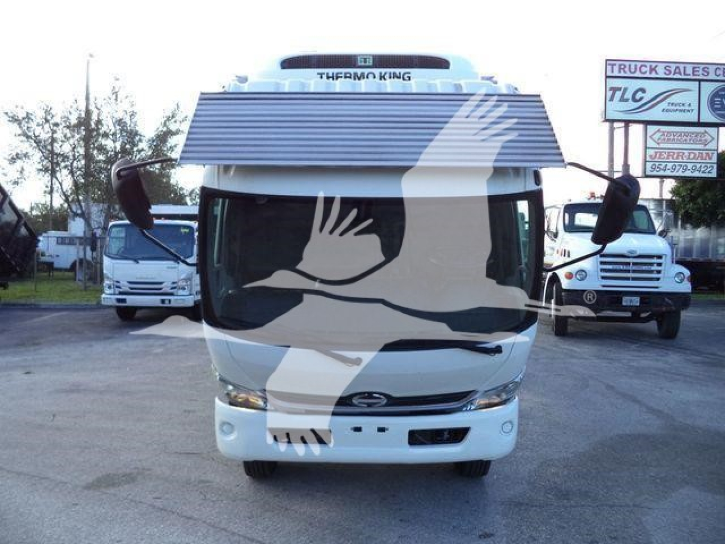Front view of a white 2020 Hino 195 refrigerated truck showing cab and windshield with side mirrors.
