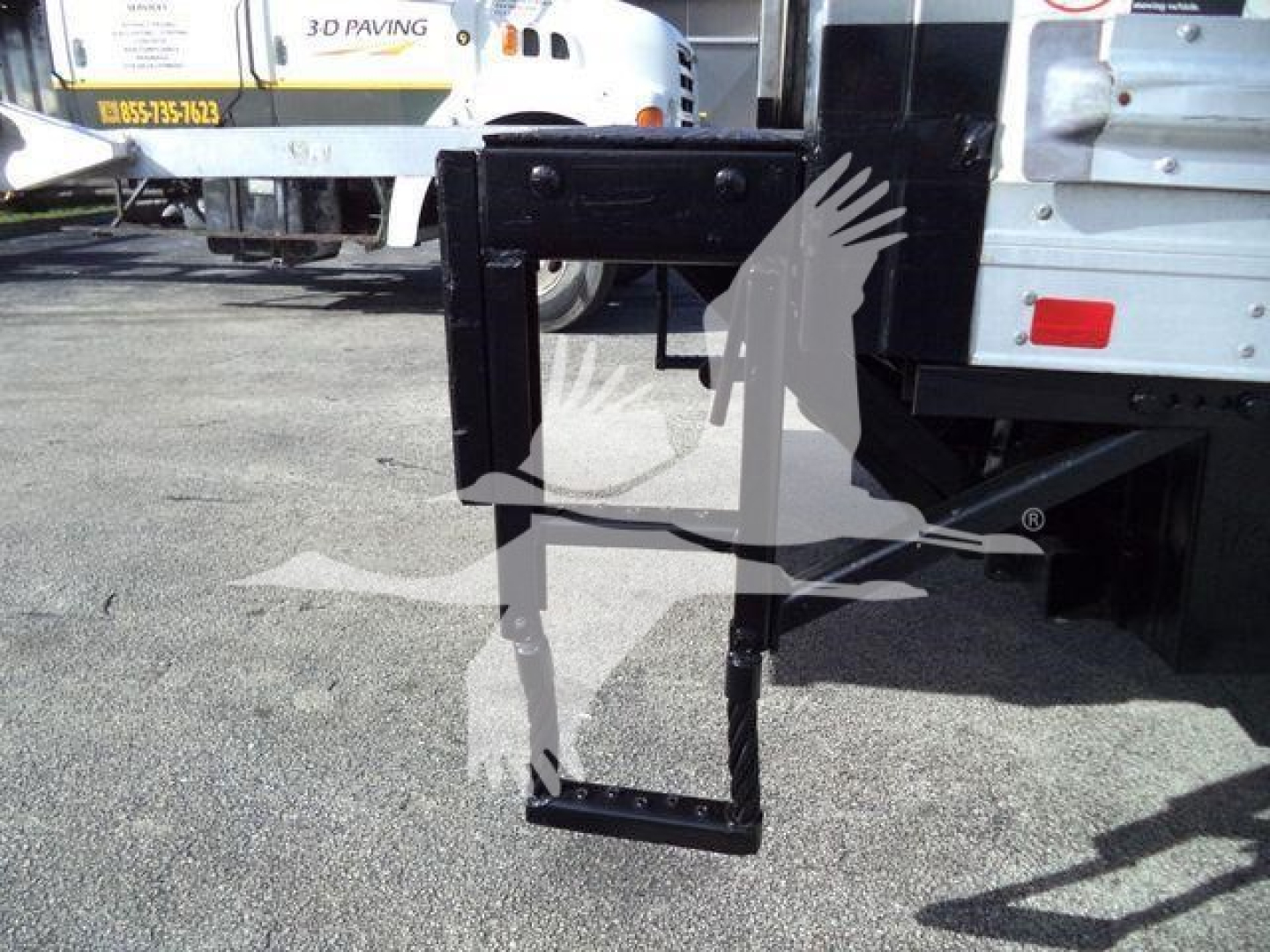 Rear view of a 2020 Hino 195 refrigerated truck showing a black undercarriage hitch/stabilizer frame and lower support bracket.
