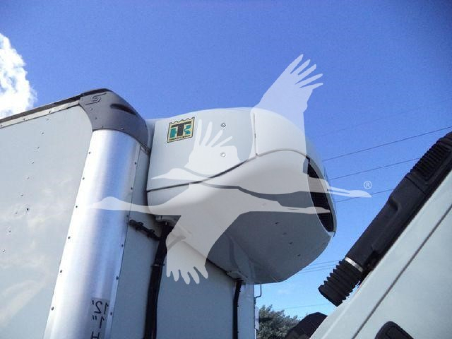 Hino refrigeration unit on truck cab showing model components and side mirrors.