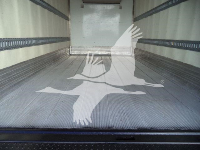 Truck bed interior of a 2020 Hino 195 refrigerated truck showing empty aluminum floor and side rails.