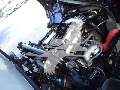 Hino 195 engine bay showing intake hoses, turbo/intercooler piping, and visible engine components under hood.