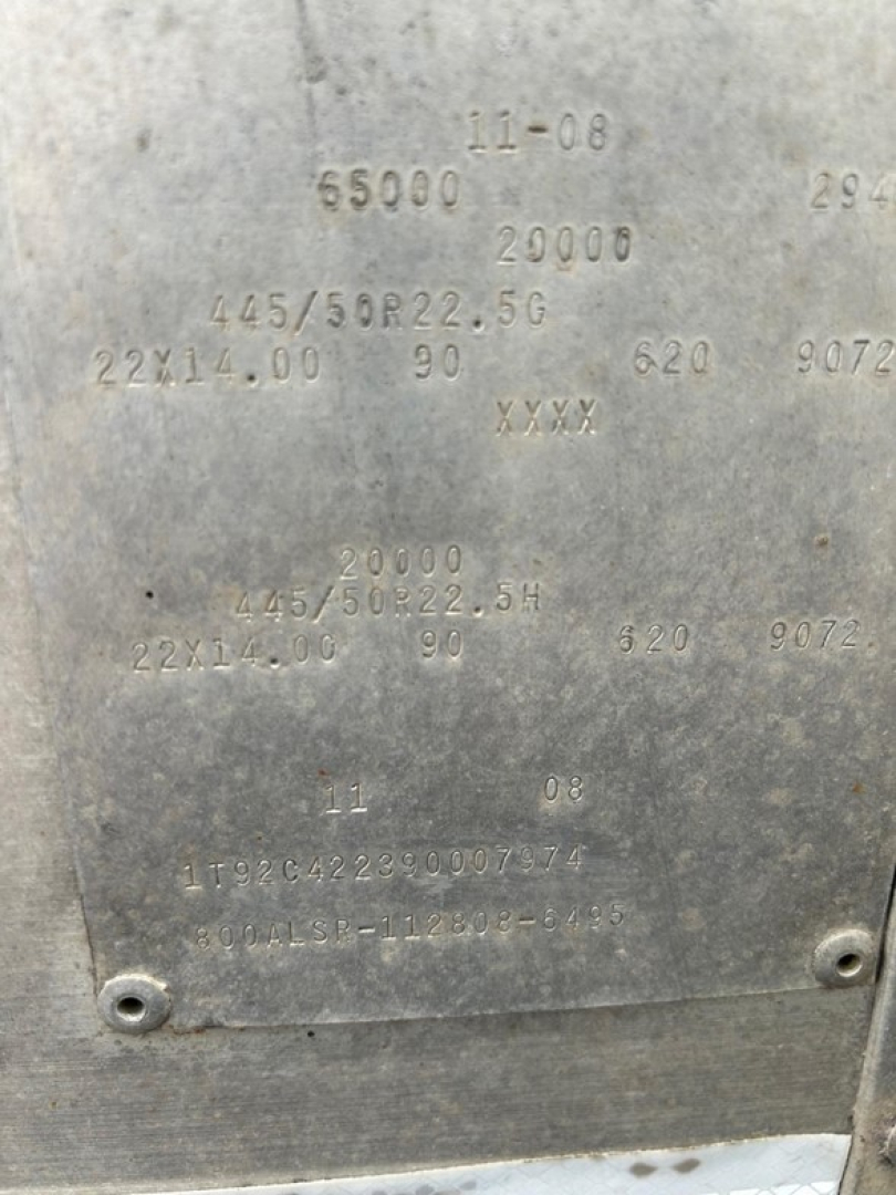 Trailers showing metal plate with embossed codes and numbers and small screws on corners.
